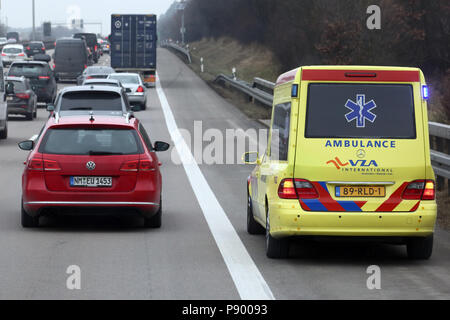 Nuernberg, Germany, Dutch ambulance drives on the traffic lane of the A9 past a traffic jam Stock Photo