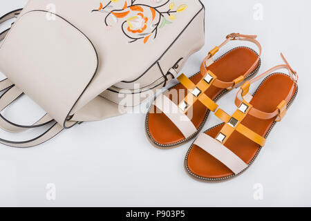 Fashionable women's sandals and backpack on white background. Stock Photo