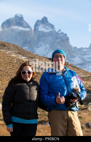 Two tourists standing on the viewing platform close to Salto Grande waterfall, Torres del Paine National Park. Stock Photo
