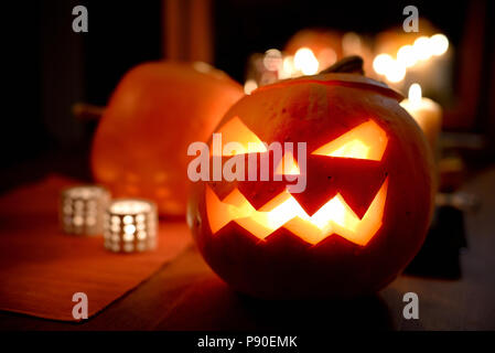 Group of spooky Halloween jack-o-lanterns lit at night Stock Photo