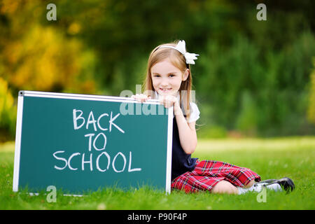 Adorable little girl feeling very excited about going back to school Stock Photo
