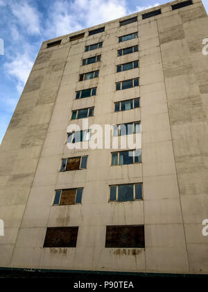 Derelict old concrete apartment building. Stock Photo