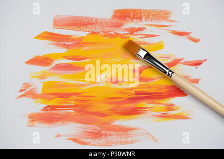 Brush strokes and palette knife oil paint red and yellow colors on a white background Stock Photo