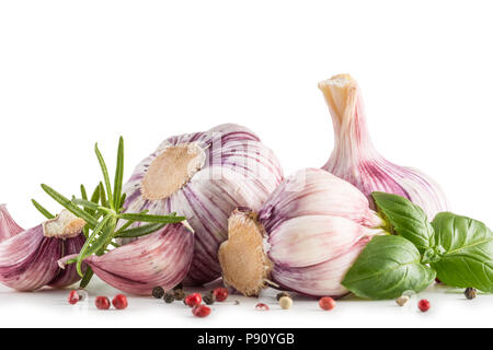 Garlic Cloves and Bulbs with rosemary and pepper isolated on white. Stock Photo
