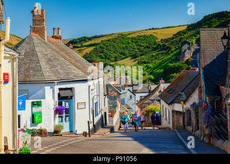 29 June 2018: Port Isaac, Cornwall, UK - Group of people walking in Fore Street during the summer heatwave. Stock Photo