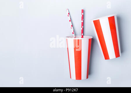 Two Empty striped paper cup on a blue background. Stock Photo