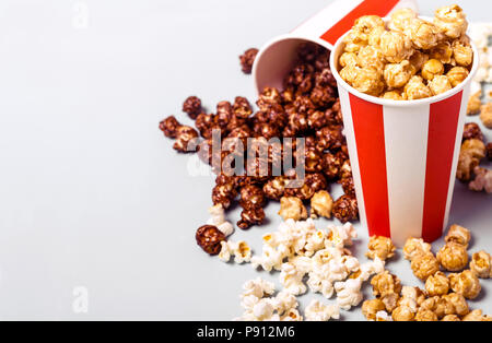 Assorted popcorn set in paper striped white red cup. Sweet and salty popcorn. Stock Photo