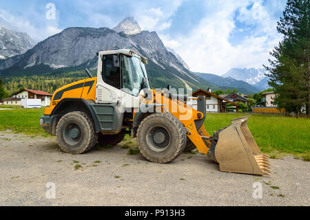 Wheeled bucket loader in the mountains. Side view. Stock Photo