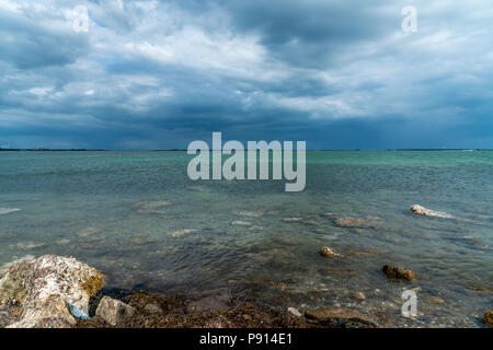 Storm clouds coming across the bay make it look very ominous. Stock Photo