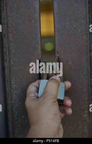 Old rusty padlock on Gate. Property protection Stock Photo