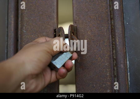 Old rusty padlock on Gate. Property protection Stock Photo