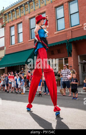 Costumed Salida Circus character marches on stilts in annual Fourth of July Parade in the small mountain town of Salida; Colorado; USA Stock Photo