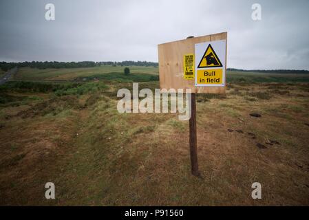 A sign in the Peak District warning of 'bull in a field', a hazard sign warning walkers about bulls. Stock Photo