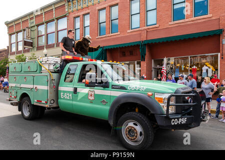 Smokey the Bear riding in US Forest Service truck; Fourth of July parade in the small mountain town of Salida, Colorado, USA Stock Photo