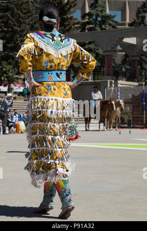 Calgary, Canada. 13th July, 2018.  Woman performs first nations jingle dance in Fluor Rope Square, downtown Calgary. The event is part of Calgary Stampede celebrations. Rosanne Tackaberry/Alamy Live News Stock Photo