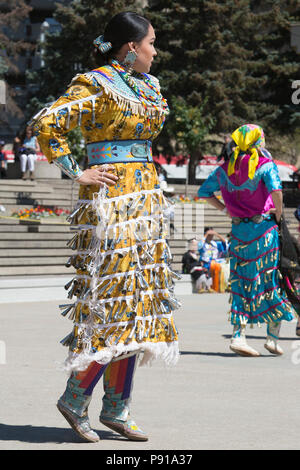 Calgary, Canada. 13th July, 2018.  Woman performs first nations jingle dance in Fluor Rope Square, downtown Calgary. The event is part of Calgary Stampede celebrations. Rosanne Tackaberry/Alamy Live News Stock Photo