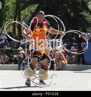 Calgary, Canada. 13th July, 2018.  Man performs first nations hoop dance in Fluor Rope Square, downtown Calgary. The event is part of Calgary Stampede celebrations. Rosanne Tackaberry/Alamy Live News Stock Photo