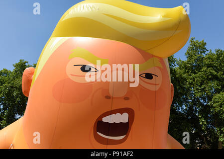 London, UK: 13th July 2018: Thousands of anti-Donald Trump protesters descended on central London in the summer heat. The president of America is on his first visit to the UK.Donald Trump Blimp flying over Parliament Square and along Whitehall. Credit: Ian Francis/Alamy Live News Stock Photo