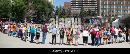 Calgary, Canada. 13th July, 2018.  First nations friendship dance with audience participation in Fluor Rope Square, downtown Calgary. The event is part of Calgary Stampede celebrations. Rosanne Tackaberry/Alamy Live News Stock Photo