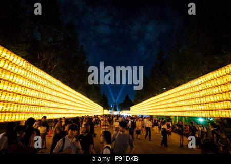 Tokyo, Japan, 13 July 2018. Visitors walk past lit paper lanterns during the Mitama Matsuri summer festival at Yasukuni Shrine on July 13, 2018 in Tokyo, Japan. The four-day traditional festival takes place during Tokyo's Bon period in July attracting about 300,000 visitors, according to the shrine. July 13, 2018 Credit: Nicolas Datiche/AFLO/Alamy Live News