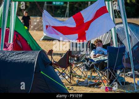 Suffolk, UK, 13 July 2018. Sleeping off the night before an exhausted England fan - The 2018 Latitude Festival, Henham Park. Suffolk 14 July 2018 Credit: Guy Bell/Alamy Live News Stock Photo