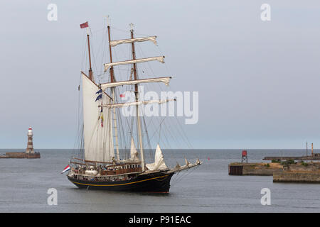 Sunderland, UK, 13 July 2018. The Gulden Leeuw, a Dutch tall ship, sails park Roker Pier and into Sthe Port of Sunderland, UK. The tall ships will be in Sunderland from 11 to 14 July,before departing on the first leg of the 2018 Tall Ships Race, to Ebsjerg in Denmark. Credit: Stuart Forster/Alamy Live News Stock Photo
