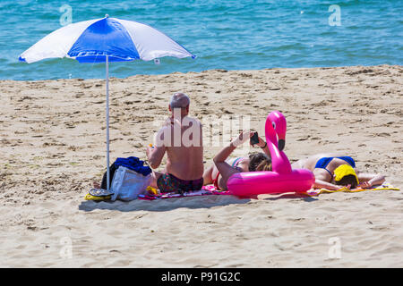 Bournemouth, Dorset, UK. 14th July 2018. UK weather: The heatwave continues with another hot sunny day, as sunseekers make the most of the glorious weather and head to the seaside at Bournemouth beaches. Sunbathers on the beach. Credit: Carolyn Jenkins/Alamy Live News Stock Photo