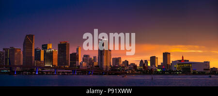 Downtown Miami skyline during sunset. The AAA Arena where the Miami Heat play is seen at right end of the panorama. Stock Photo