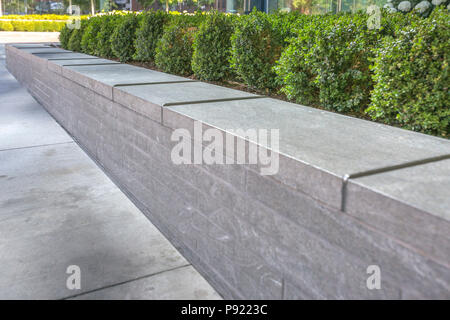Metal gaurds on the edge of concrete planter Stock Photo