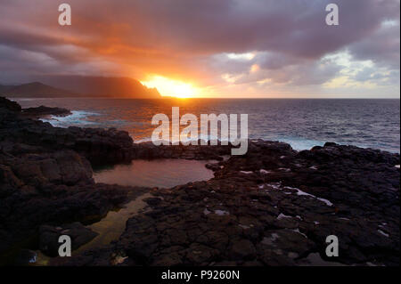 Queen's Bath on sunset on the island of Kauai, Hawaii. The pools are sinkholes surrounded by lava rock. Stock Photo