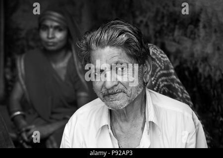 A Rajasthani MAN and his WIFE in a doorway in JOHDPUR - RAJASTHAN, INDIA Stock Photo