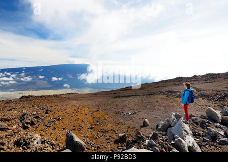 Tourist admiring breathtaking view of Mauna Loa volcano on the Big Island of Hawaii. The largest subaerial volcano in both mass and volume, Mauna Loa  Stock Photo