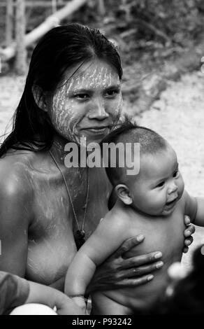 Moken (sea gypsy) women & child in her village on Ko Surin Thai Island in Mu Ko Surin National Park -  NORTH ANDAMAN SEA, THAILAND Stock Photo