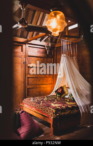 https://l450v.alamy.com/450v/p932nw/hippie-style-wooden-room-with-traditional-bed-covered-by-colorful-blanket-with-ornament-hanging-baldachin-and-dreamcatcher-p932nw.jpg