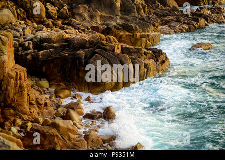 Huge waves breaking on a rocky beach over Porth Nanven in the Cot Valley of Cornwall, England Stock Photo