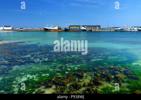 Blue waters in harbor of Kilronan of Inishmore, the largest of the Aran Islands in Galway Bay. Famous for its strong Irish culture, loyalty to the Iri Stock Photo