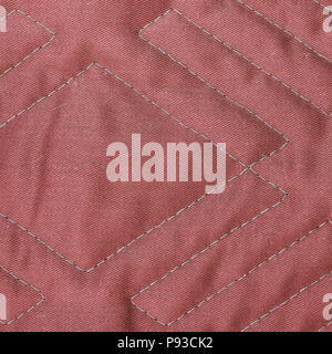 Red quilted fabric texture with geometric pattern Stock Photo