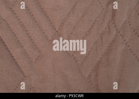 Brown quilted fabric texture with geometric pattern Stock Photo