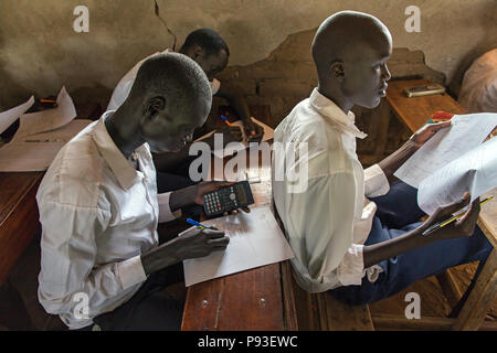 Kakuma, Kenya - Students write exams in a classroom of a school building in the Kakuma refugee camp. Stock Photo