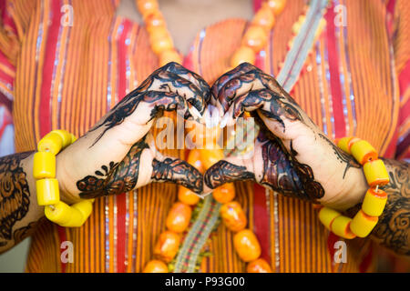 African Woman making a Heart Shape with Henna Painted Hands Stock Photo