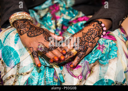 Black and Brown Henna Hands Drawings on Women for African Wedding Ceremony with Big Rings Stock Photo