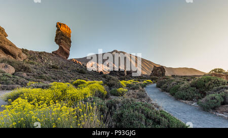 View of unique Roques de Garcia unique rock formation with famous Pico del Teide mountain volcano summit in the background on a sunny morning. Teide N Stock Photo