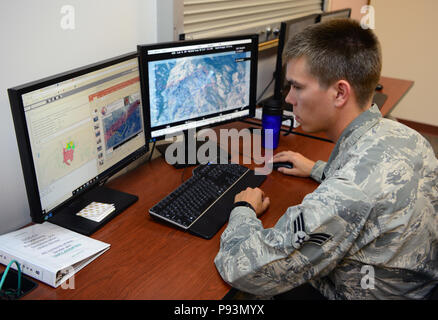 Senior Airman Austin Kingfisher, 234th Intelligence Squadron aerial imagery analyst, provides analysis for the Klamathon Fire July 11, 2018, at Beale Air Force Base, California. The imagery analysts coordinate with crews on the ground, which allow them to fight the fires more effectively. They notify the crews on the ground if the fire has gotten past barriers created by bulldozers or if new fires have been started by embers. During emergencies, they often conduct 24-hour operations until the situation is under control. (U.S. Air Force photo/Airman 1st Class Tristan D. Viglianco) Stock Photo