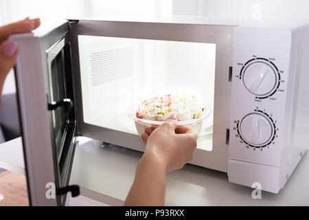 https://l450v.alamy.com/450v/p93rxx/close-up-of-a-womans-hand-heating-food-in-microwave-oven-p93rxx.jpg