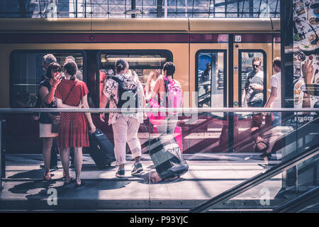 Berlin, Germany - july 2017: Traveling people with luggage at train station platform at  main station (Hauptbahnhof)   in Berlin, Germany