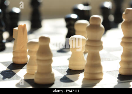 A game of chess in progress. Focus is on the white single pawn Stock Photo