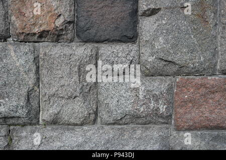 Rubble gray and brown rectangular stone wall, rubblework. Stock Photo