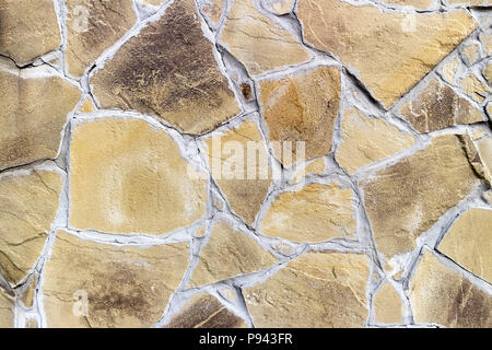 Wall with irregularly shaped brown tiles. Stock Photo