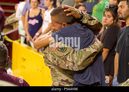 More than 400 Arizona Army National Guard Soldiers with 1st Battalion, 158th Infantry Regiment rally together with their families inside Wells Fargo Arena in Tempe, Arizona for an emotional farewell ceremony July 7, as the Battalion prepares for their deployment in support of Operation Spartan Shield (Photo by Army Sgt. Richard W. Hoppe, released). Stock Photo