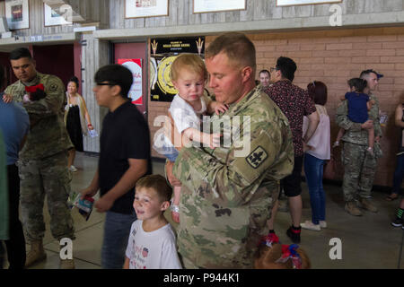 More than 400 Arizona Army National Guard Soldiers with 1st Battalion, 158th Infantry Regiment rally together with their families inside Wells Fargo Arena in Tempe, Arizona for an emotional farewell ceremony July 7, as the Battalion prepares for their deployment in support of Operation Spartan Shield (Photo by Army Sgt. 1st Class Robert Freese, released). Stock Photo